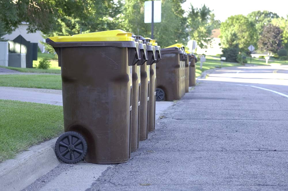 trashcans on curb for pickup Pederson Sanitation Fort Dodge IA